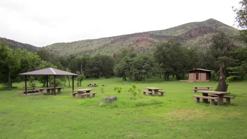 Grassy picnic area with bathroom and small ramada