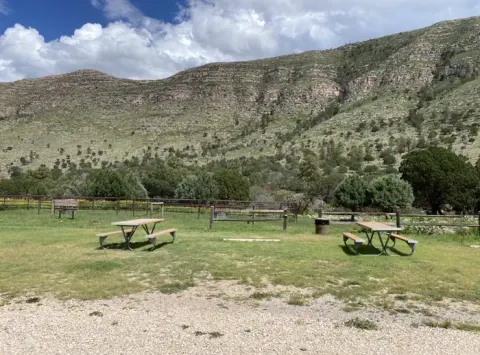 Dog Canyon RV campsite, mountains in the background and a picnic table for campers