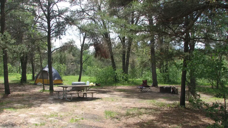 A campsite with a tent set up on it in the Meadows ORV Campground.