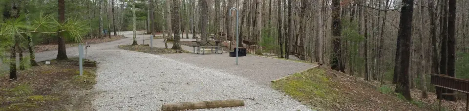 Rocky parking pad with campsite nearby.