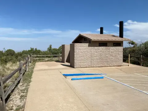 Vault type restroom located in the tent camping loop. There are 2 parking spaces one is accessible. This restroom is located between the group campsites.