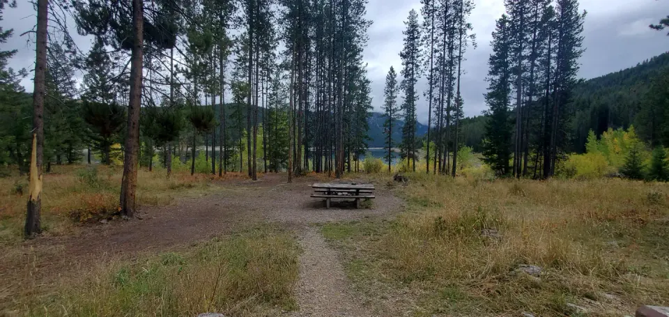 Campsite with picnic tables and view of reservoir