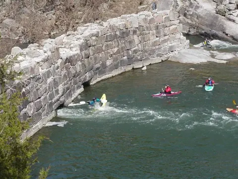 Kayakers Playing Around Old Minig Company Dam