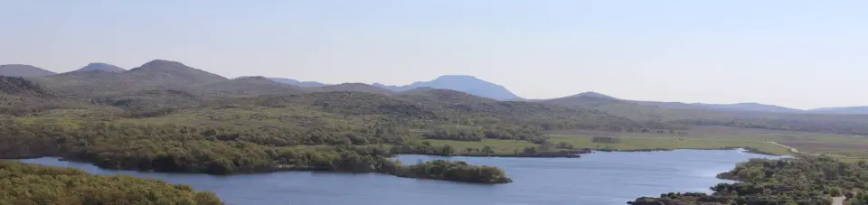 The Wichita Mountains line the horizon beyond the shore of Quanah Parker Lake.