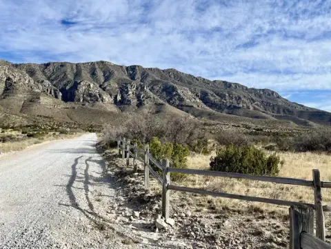 Gravel road leading to the Frijole Ranch area. Guadalupe Mountains are visible in the background.