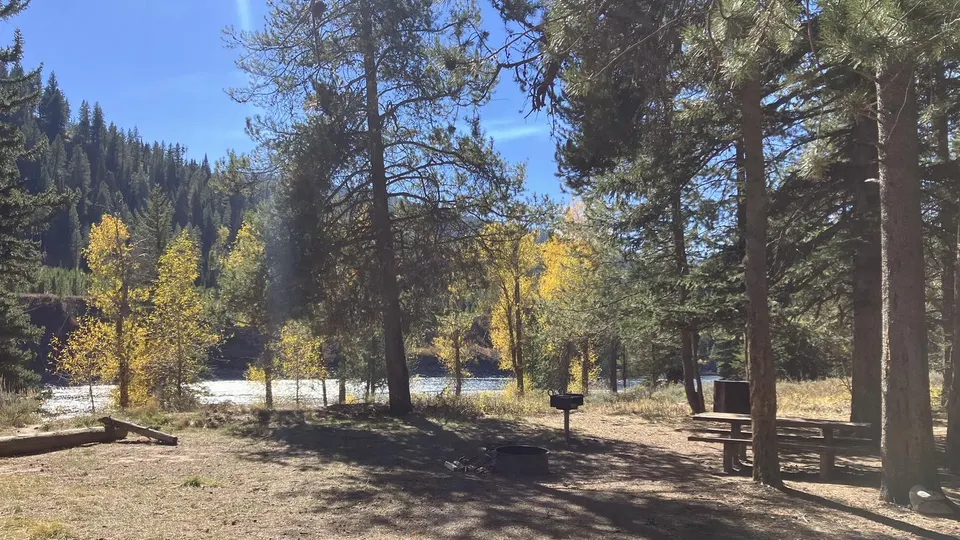 Campsite with table and fire ring looking over Snake River